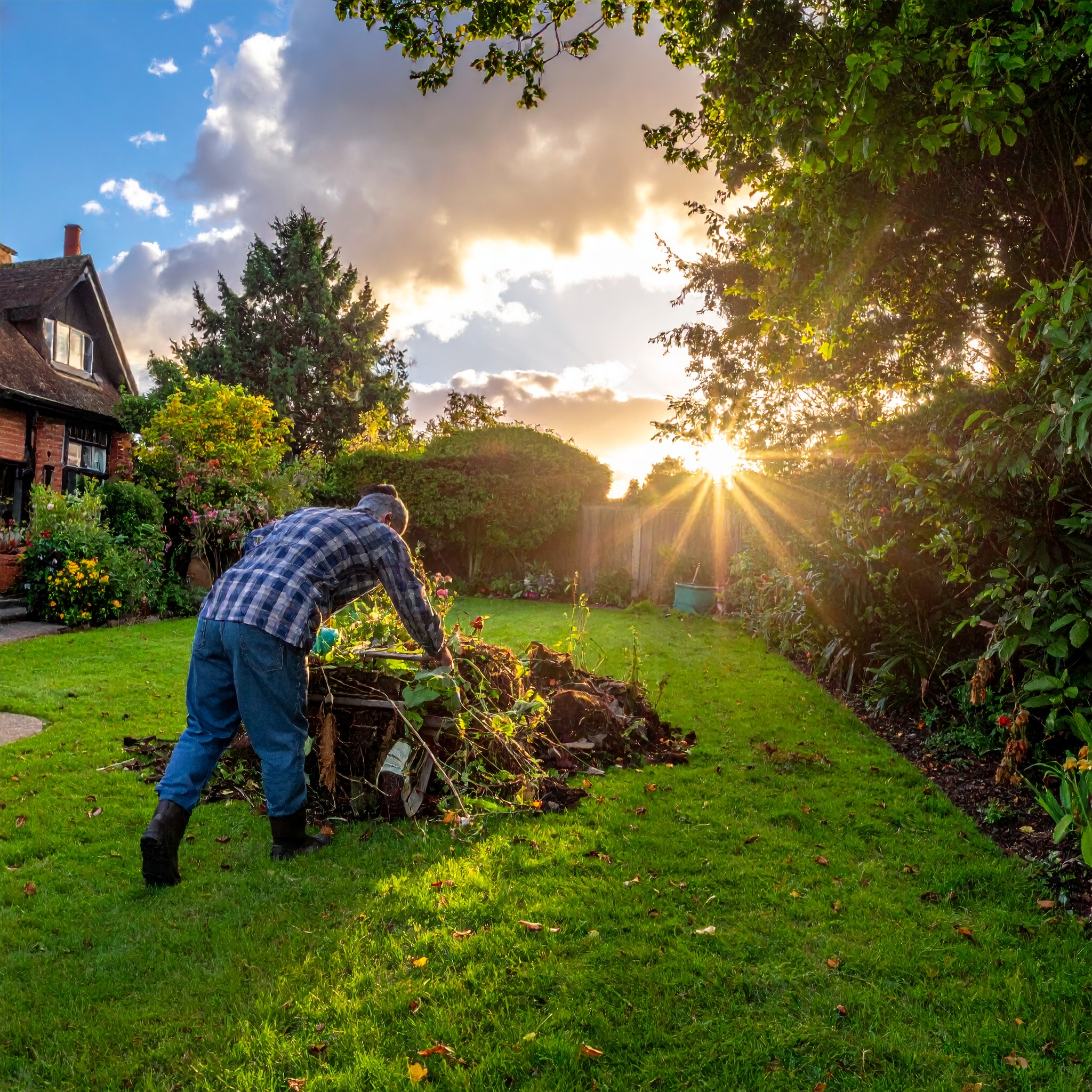 Gardener tending to compost pile.